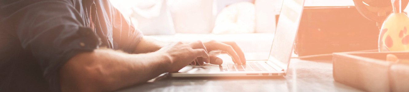 Man using his laptop at a desk